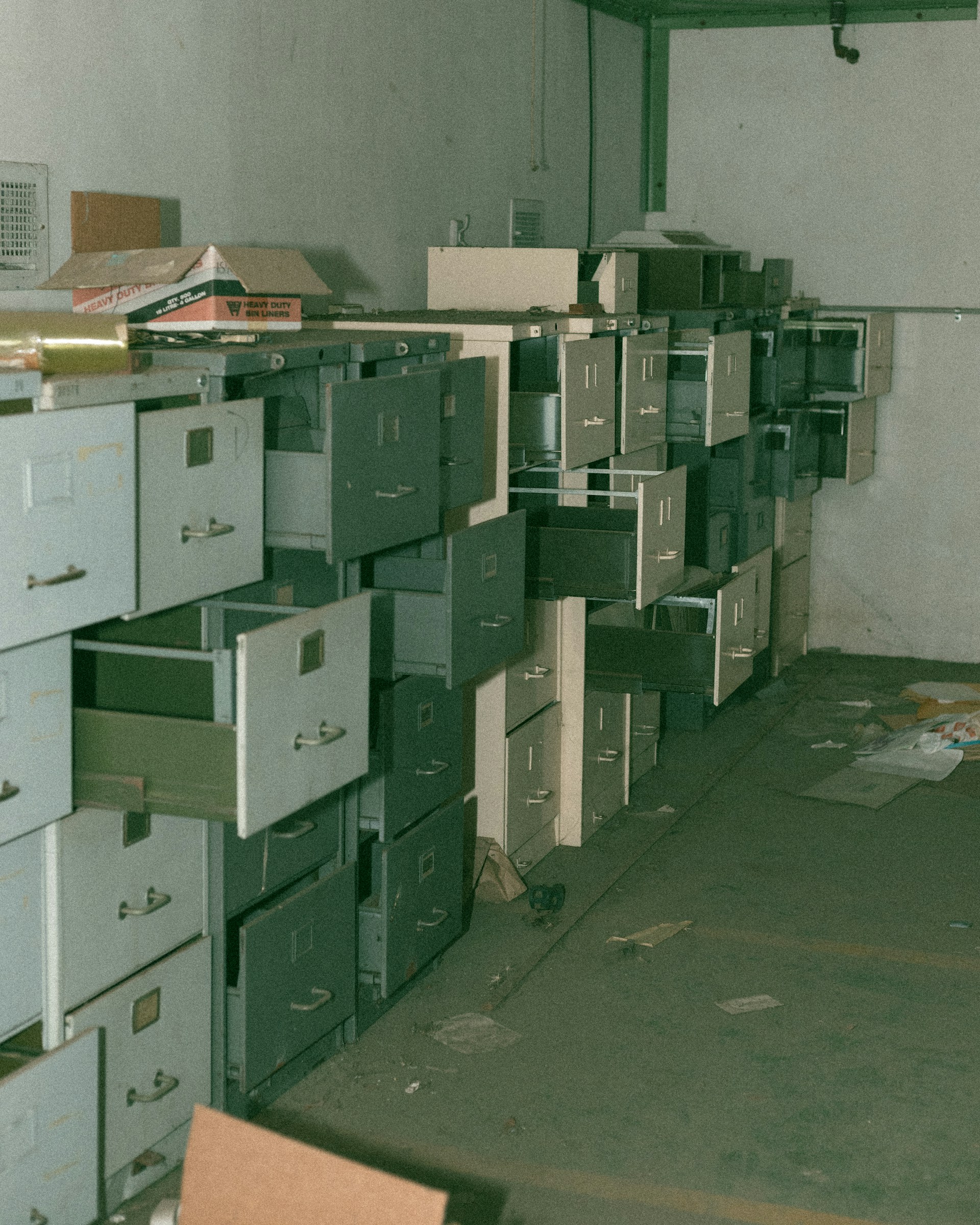 Row after row of filing cabinets, drawers open.